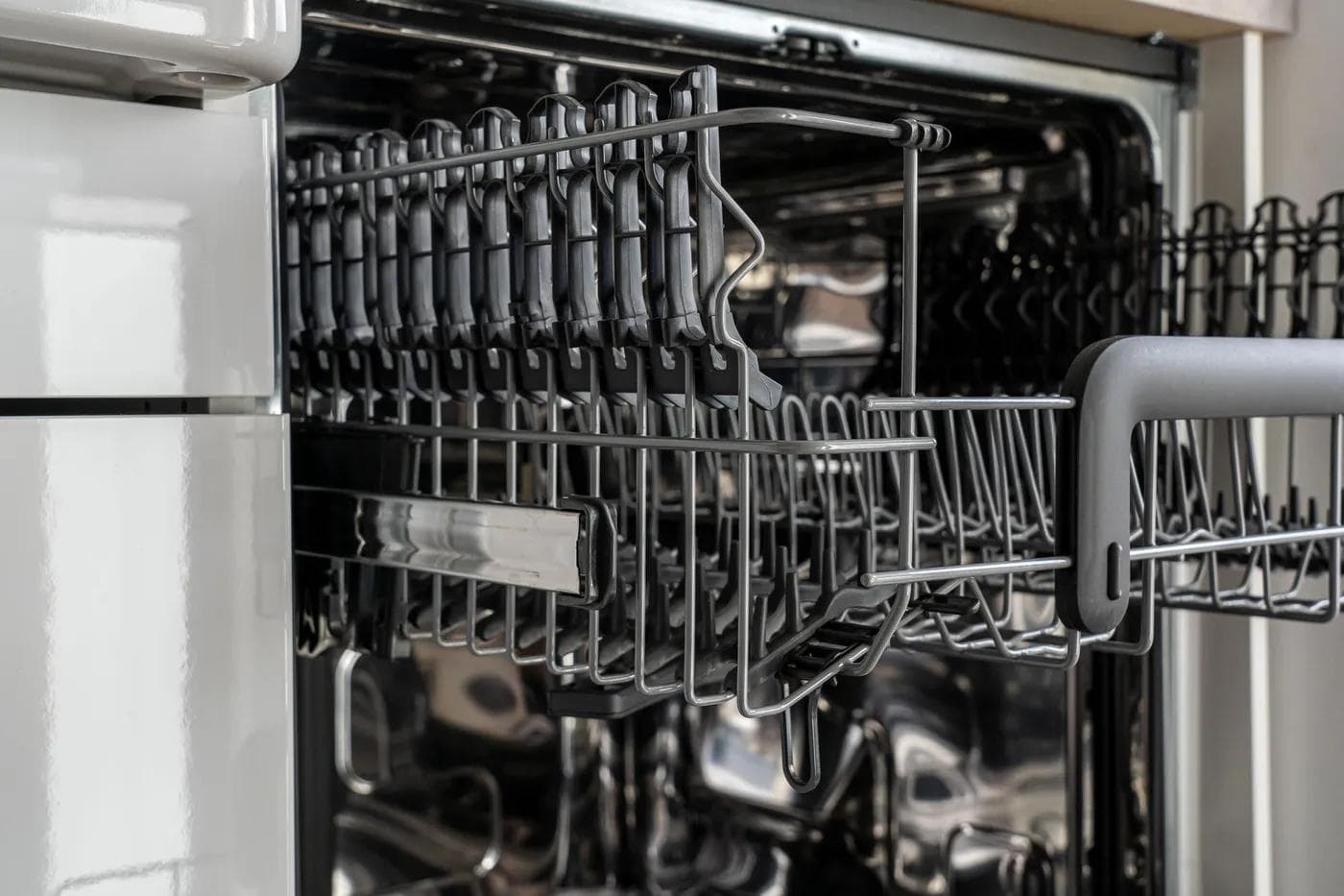 Open dishwasher with its lower rack pulled out