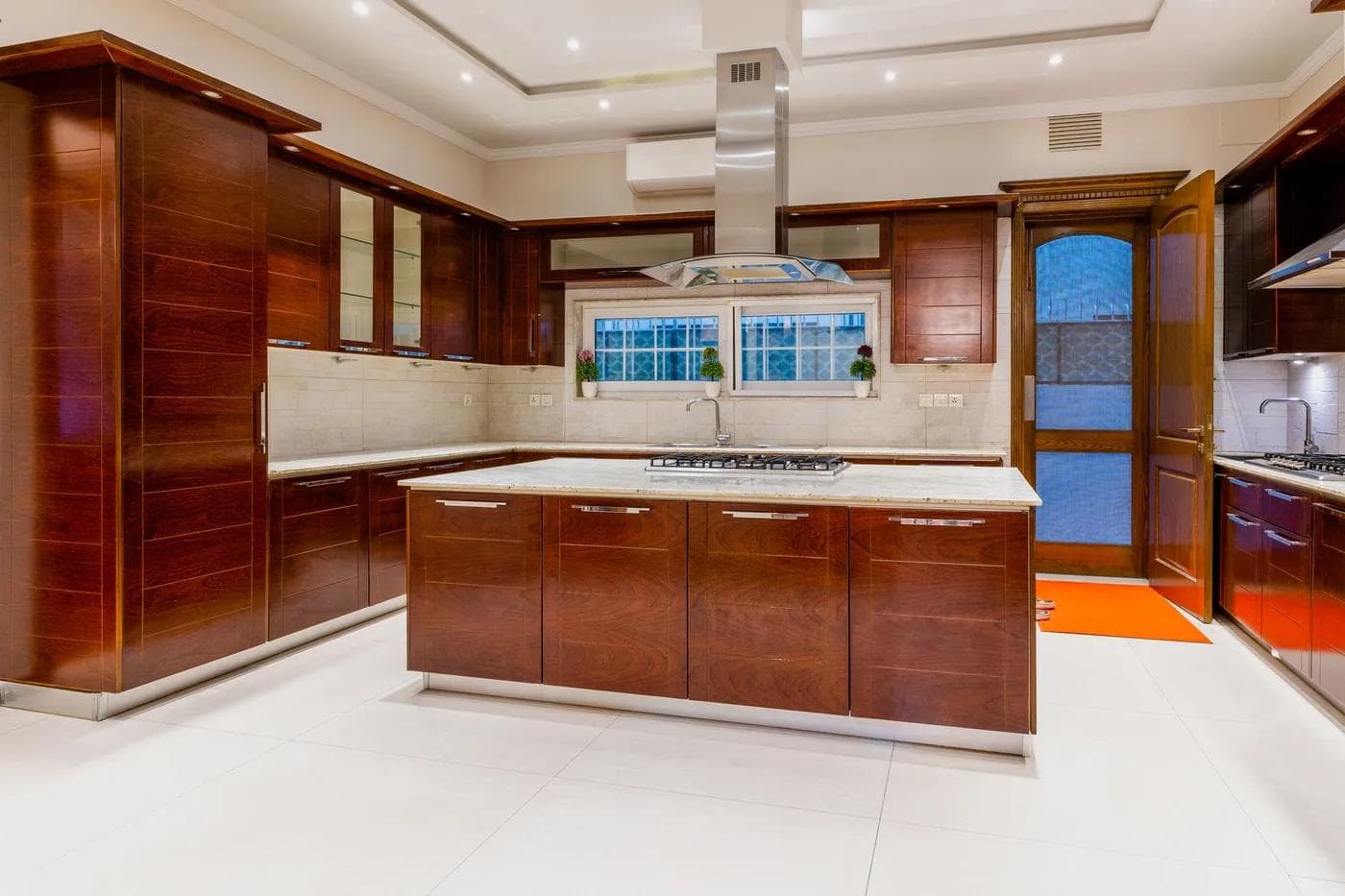 Modern kitchen with dark wood cabinets and marble countertops